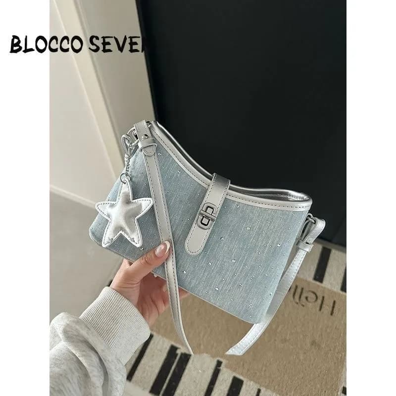 BLOCCO SEVEN light blue sparkle denim mini shoulder bag with metallic silver strap, turn lock, and puffy star charm