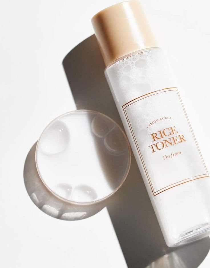 Brightening rice toner texture applied on skin close-up